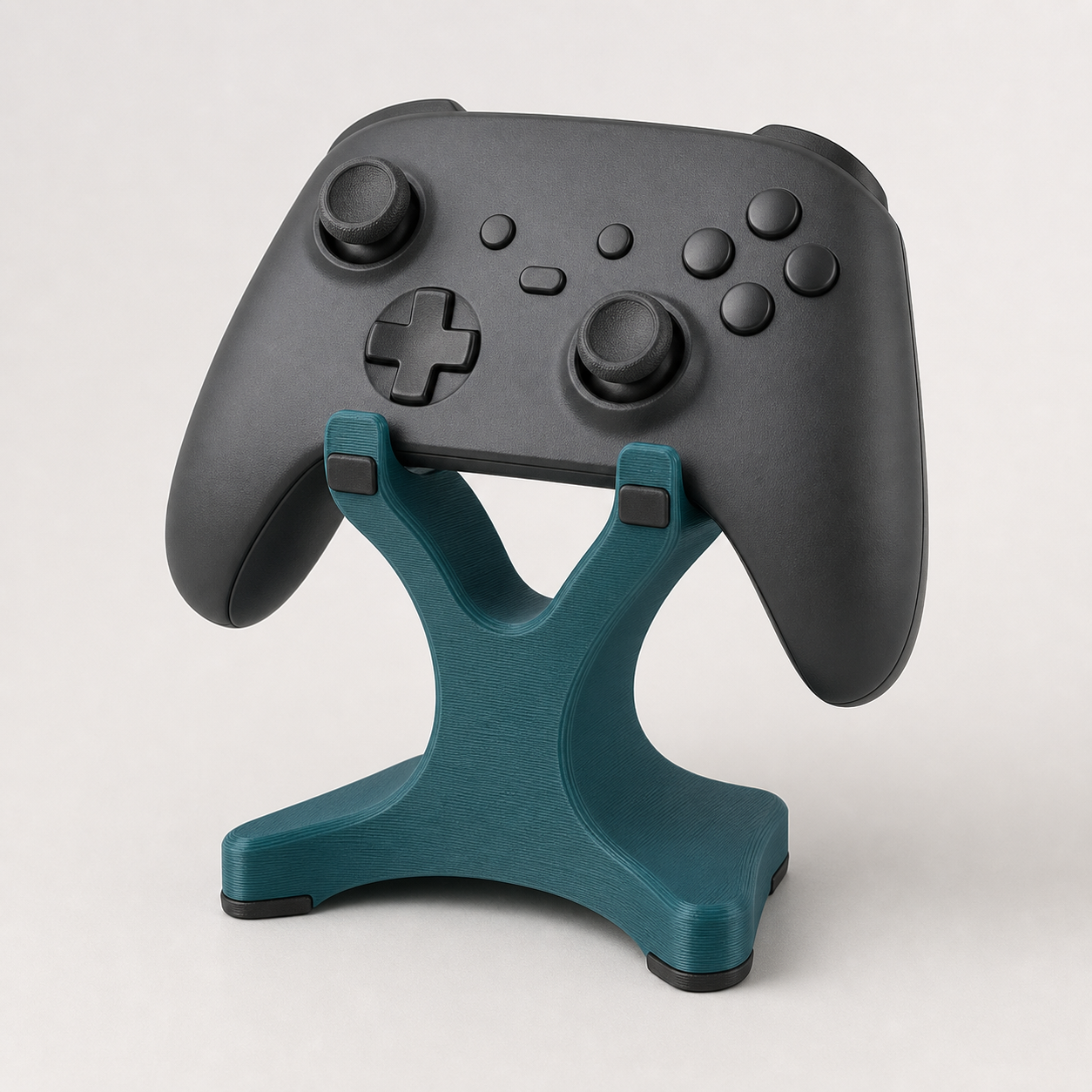 Unbranded charcoal game controller displayed on a deep-teal 3D-printed game controller stand