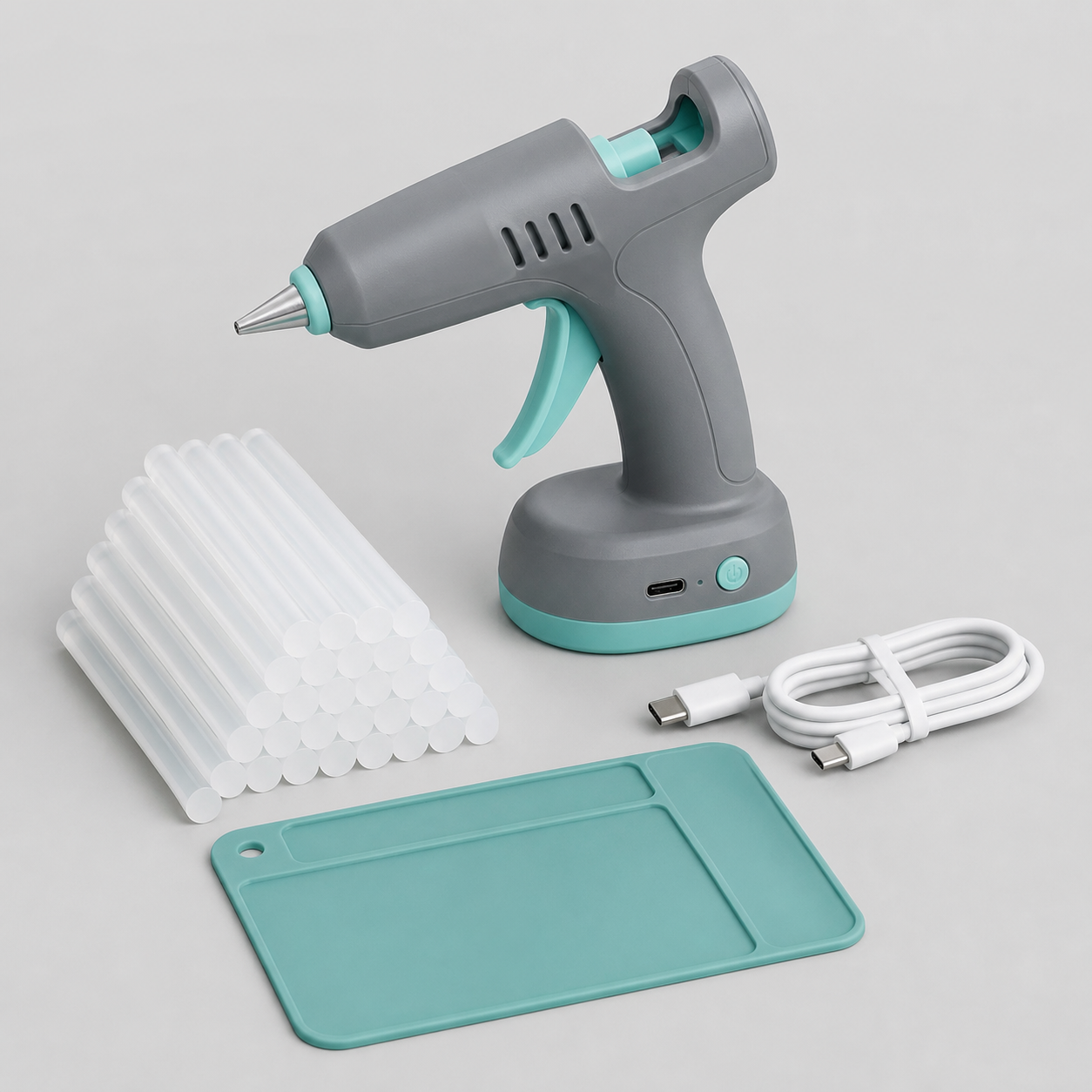 Cordless rechargeable mini hot glue gun kit with glue sticks, USB cable and silicone work mat