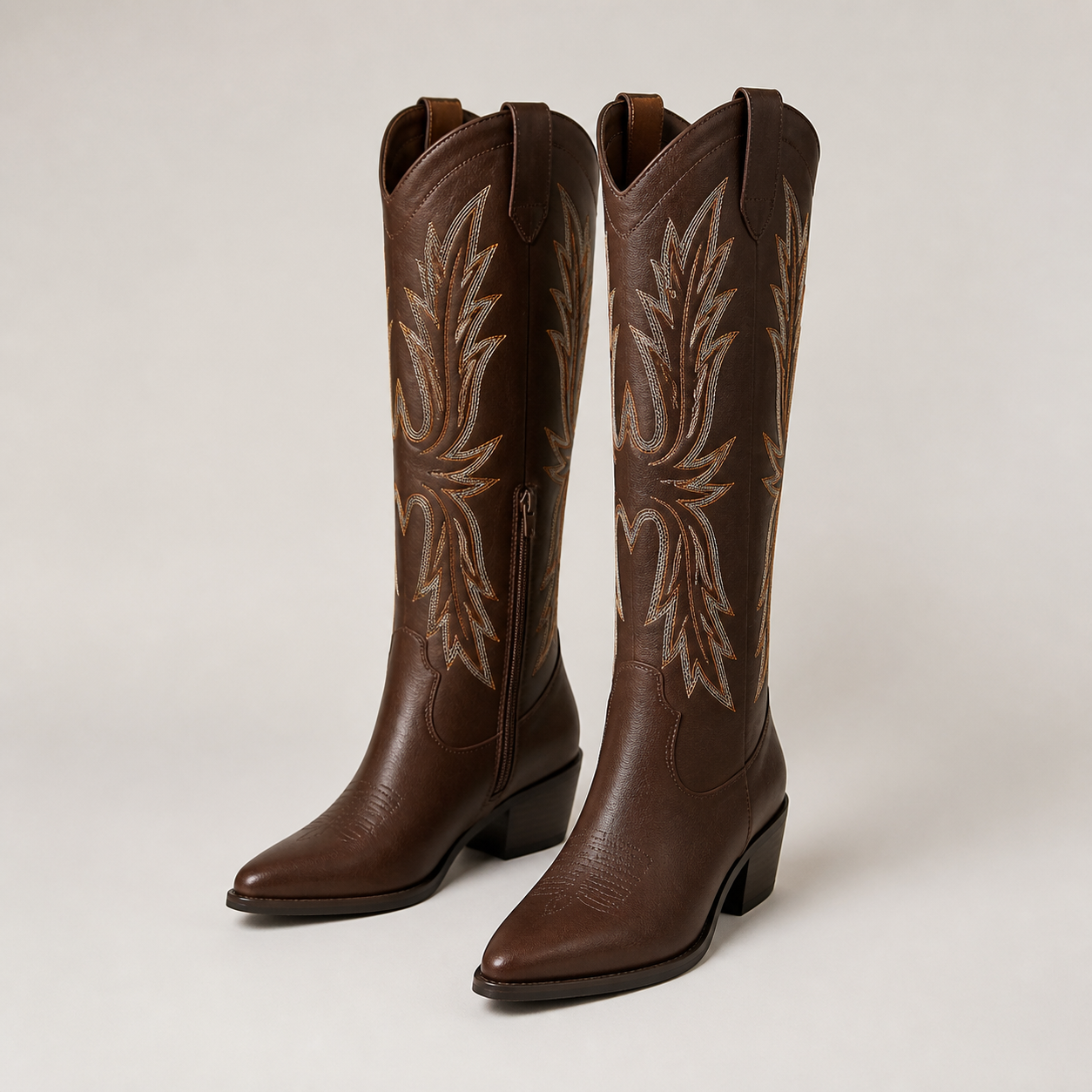 Pair of unbranded dark brown embroidered knee-high western boots with pointed toes and block heels