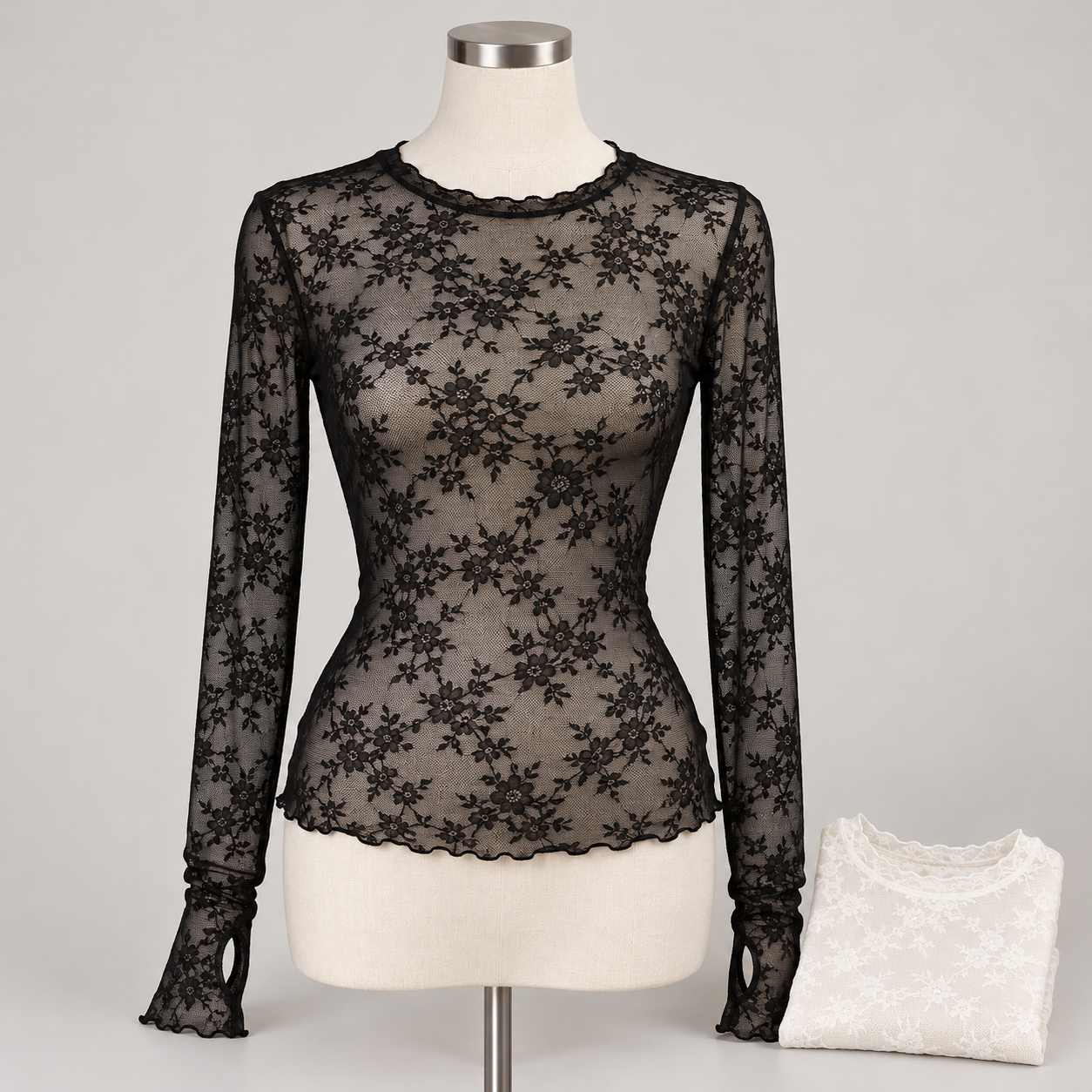 Unbranded black floral lace mesh long sleeve layering top on a dress form