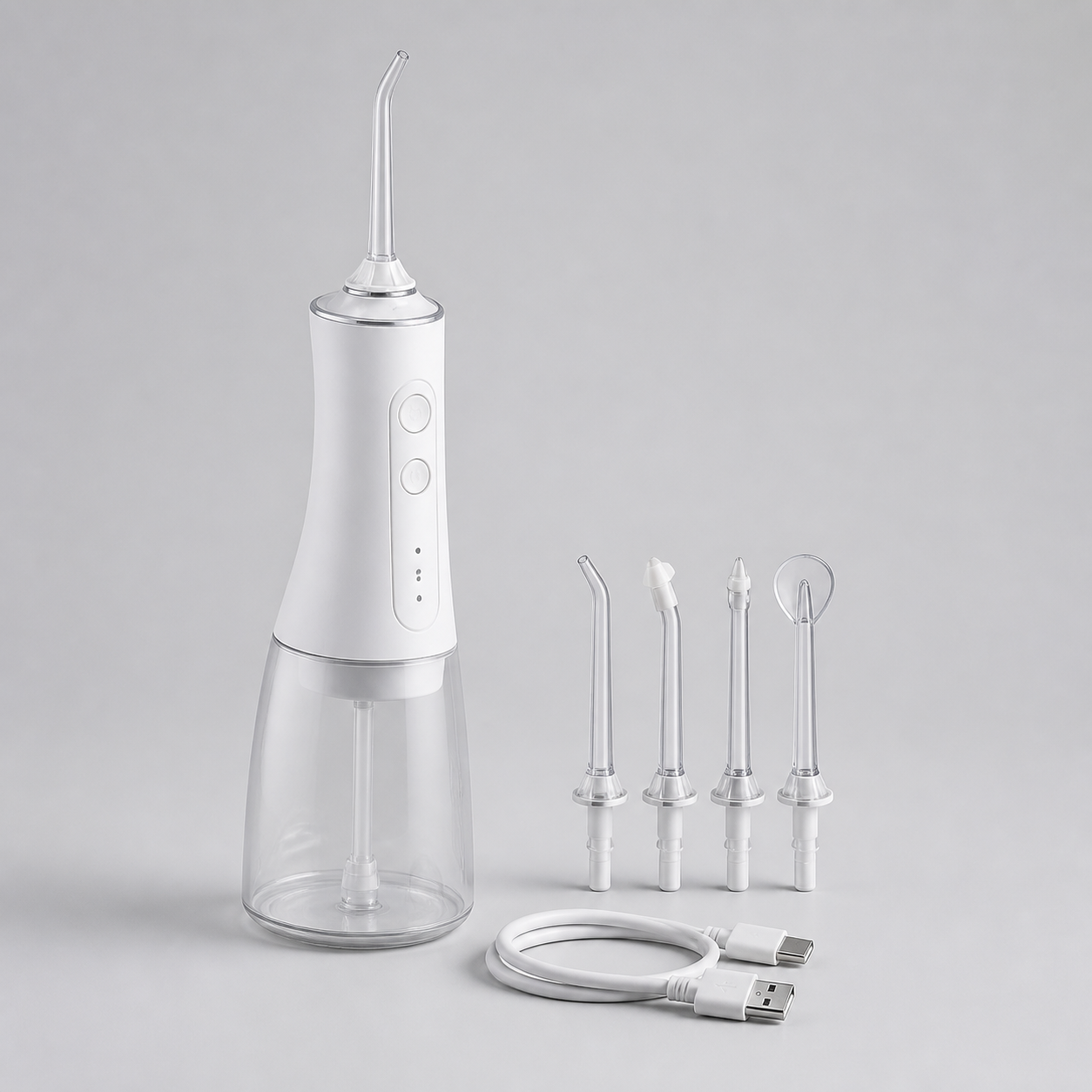 Matte white portable rechargeable water flosser with clear reservoir, four interchangeable nozzles and USB cable