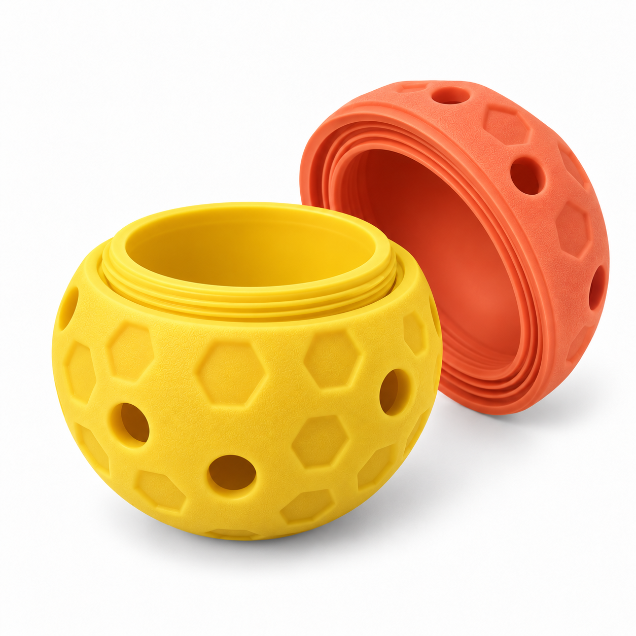 Illustrative yellow and coral honeycomb-pattern refillable dog enrichment ball shown opened
