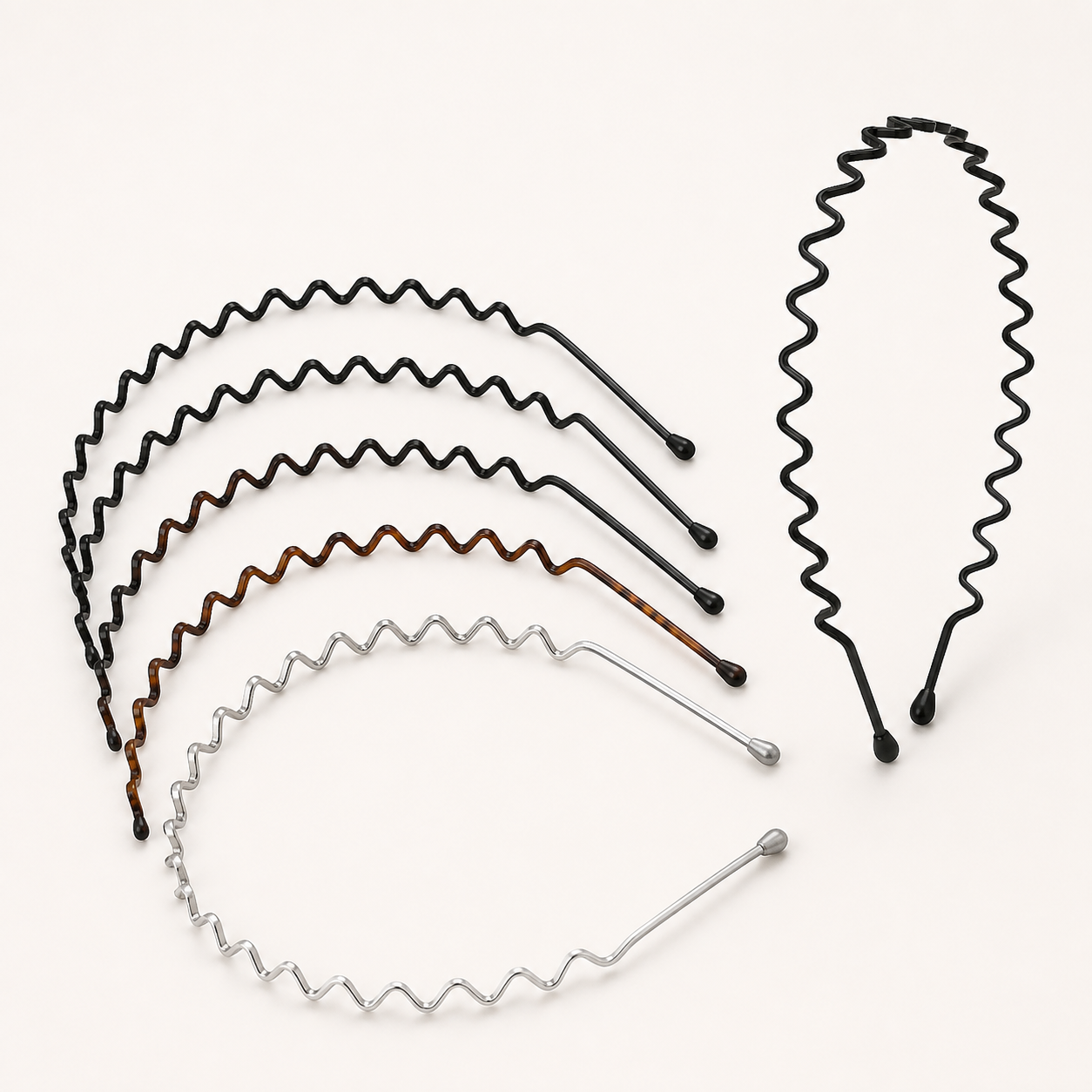 Six slim metal zigzag headbands in black, tortoiseshell brown, and silver finishes