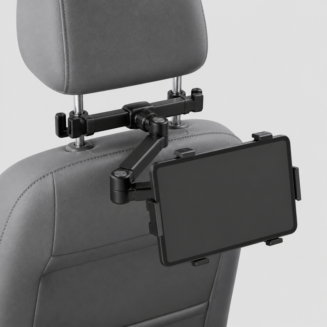 Black adjustable car headrest tablet holder mounted between metal headrest posts with a blank tablet
