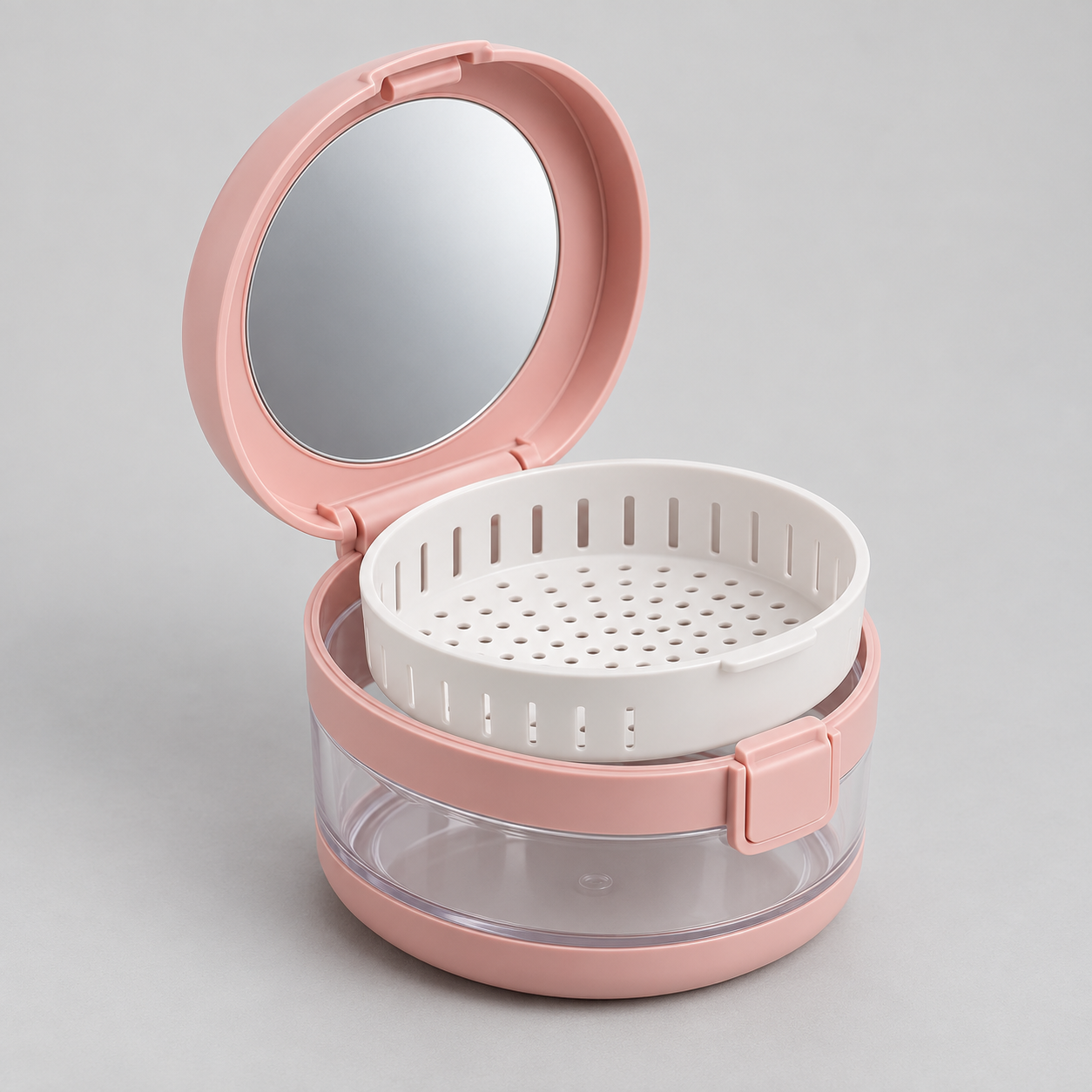 Open pink three-in-one retainer case with lid mirror, white draining basket, and clear soaking chamber