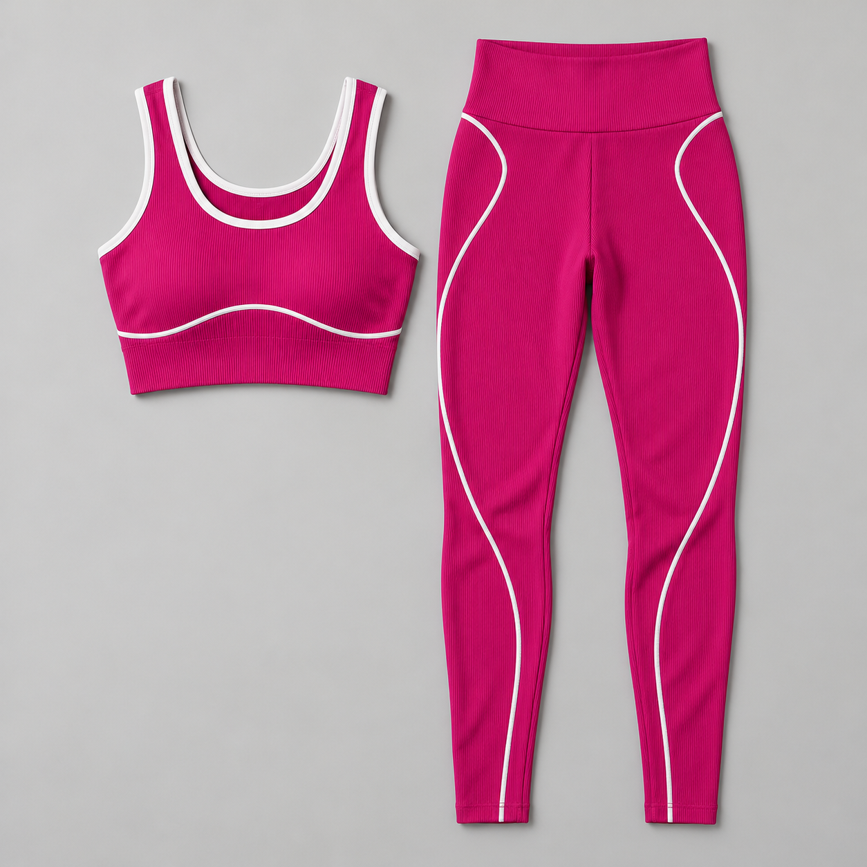Magenta two-piece activewear set with white-piped crop sports tank and high-waist full-length leggings